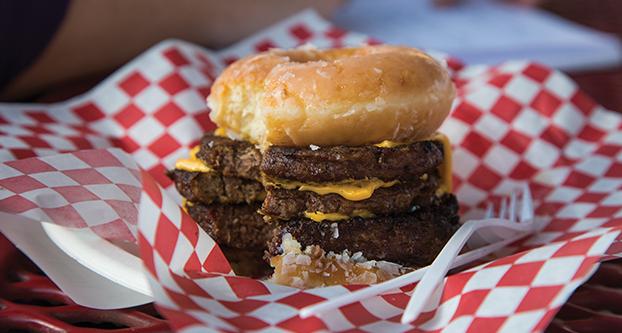 The Krispy Kreme triple-decker cheeseburger sold at the Chicken Charlie  booth located at the Big Fresno fair. Darlene Wendels / The Collegian 
