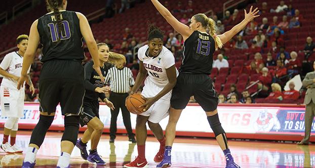 Fresno State senior Toni Smith attempts to drive past Washington center Katie Collier (13) during Friday’s nonconference matchup with the Huskies at Save Mart Center. (Darlene Wendels/The Collegian)