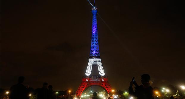 On the third day of national mourning, the Eiffel Tower was lighted in the national colors after going dark on Nov. 16, 2015 in Paris. (Carolyn Cole/Los Angeles Times/TNS)