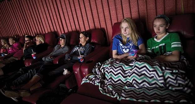 Mara Lindquist and Abby Persoon, right, share a blanket as they relax in recliner chairs at Marcus Theater in Oakdale, Minn., which offers the luxurious seats. Rennee Jones Schneider/Minneapolis Star Tribune/TNS