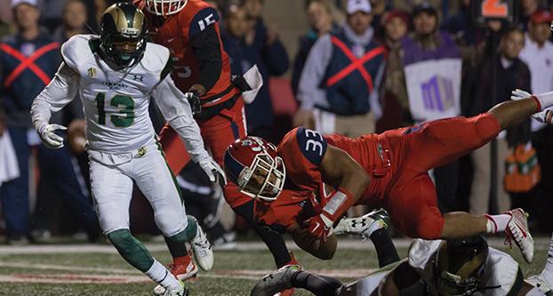 Fresno State senior running back Marteze Waller falls to the turf after being tackled during the Nov. 28 Senior Night game against Colorado State at Bulldog Stadium. (Darlene Wendels/The Collegian)