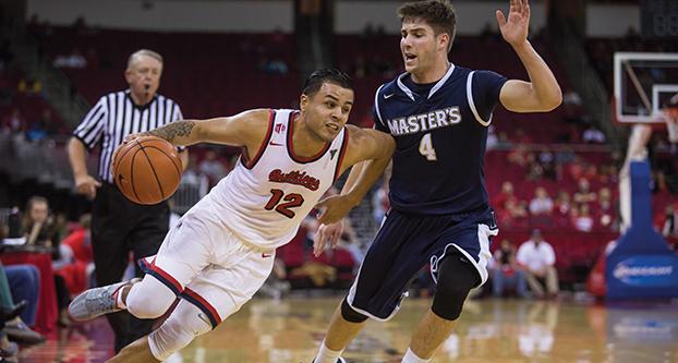 Fresno State senior guard Cezar Guerrero battles with Master’s College guard Reid Shackelford during Thursday’s nonconference matchup at Save Mart Center. (Darlene Wendels/The Collegian)