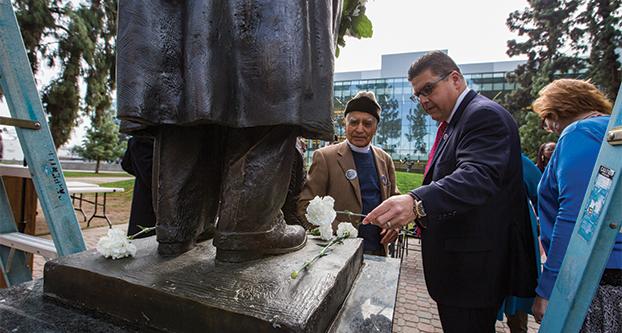 Fresno State President Joseph I. Castro and emeritus professor Sudarshan Kapoor, place flowers on the Martin Luther King, Jr. statue during the Martin Luther King Commemoration Ceremony held in the Peace Garden, Thursday, Jan. 21, 2016. The ceremony included several speakers such as Vice President of Student Affairs Frank Lamas, Rabbi Laura Novak Winer of Temple Beth Israel and a keynote speech by Pastor Tobaise Brookins of Bethesda Apostolic Church. (Photo by Darlene Wendels/The Collegian)