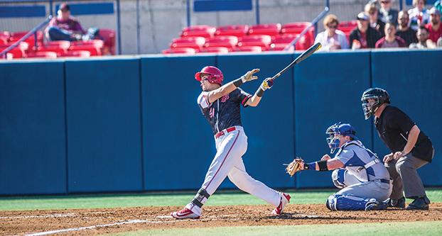 Fresno State sophomore outfielder Aaron Arruda hits a home run, the Bulldogs’ first of the season, during Sunday’s 7-3 win over Creighton. (Khone Saysamongdy/The Collegian)