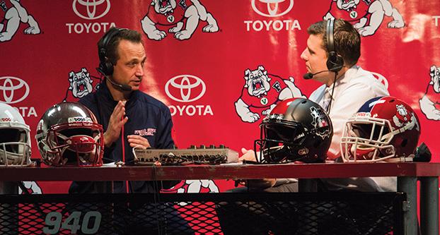 Fresno State offensive coordinator Eric Kiesau talks with 940 ESPN radio host Paul Loeffler about the Bulldogs’ new recruits during National Signing Day. (Ricky Gutierrez/The Collegian)