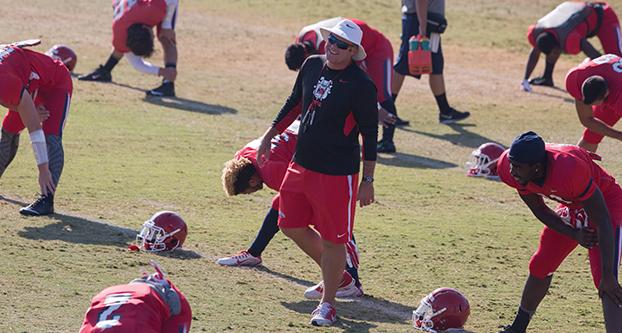 Fresno State head coach Tim DeRuyter and the Bulldogs during a fall 2015 practice. (Darlene Wendels/The Collegian)