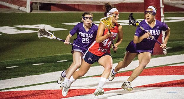 Fresno State sophomore Abigail Bergevin (44) evades a pair of Furman players during Monday’s 7-4 win over the Paladins. (Ricky Gutierrez/The Collegian)