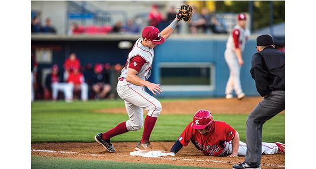 Fresno State junior outfielder Austin Guibor (33) retreats and dives back to first base to avoid being tagged out during Tuesday’s 3-2 loss to Oklahoma. (Khone Saysamongdy/The Collegian)