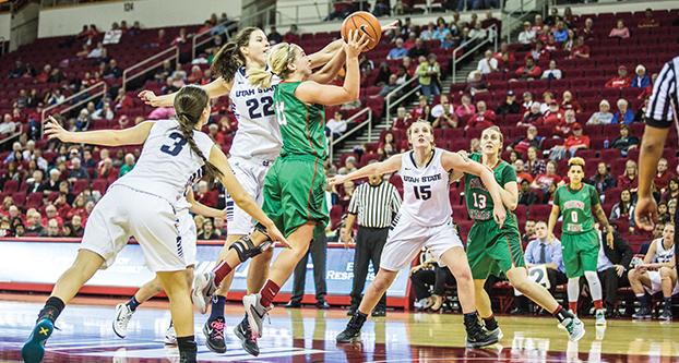 Fresno State senior guard Alex Furr attempts a shot after driving past a couple of Utah State defenders during Friday’s Senior Night matchup against the Aggies. (Khone Saysamongdy/The Collegian)