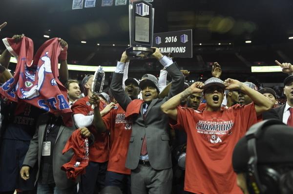 Fresno State head coach Rodney Terry and the men’s basketball team celebrate after winning the Mountain West Tournament title on March 12 in Las Vegas. (Steve Nowland/NCAA Photos)