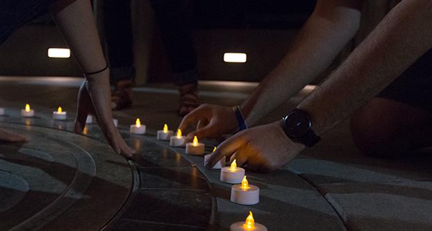 Fresno State students set candles down inside of the Armenian Genocide Monument to commemorate the 101 anniversary of the Armenian Genocide, Wednesday, April 20, 2016. (Darlene Wendels/The Collegian)