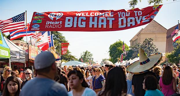 Guests walking down the Big Hat Day festival hosted in Old Town Clovis. The festival encourages the community to take out their crazy hats and show them off to the crowds. (Ricky Gutierrez/The Collegian)