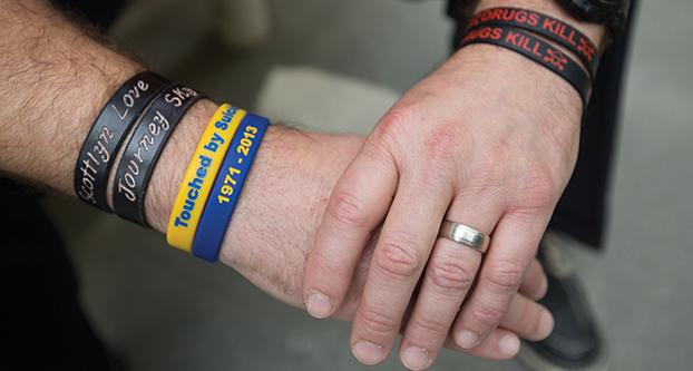 Scott S., a recovering alcoholic and drug addict, displays several bracelets he wears that hold special meaning to him, Thursday, April 7, 2016. The yellow and blue bracelets are in memory of Scott’s cousin who was a drug user and committed suicide, and they are also representative of when Scott himself contemplated suicide. He also wears two bracelets with the names of his daughters Scottlyn Love and Journey Sky. The “drugs kill” bracelets are representative of Scott’s recovery as well as his involvement as a student volunteer with Bulldogs of Recovery. (Darlene Wendels/The Collegian)
