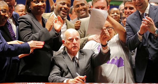 California Governor Brown signs a minimum wage bill at the Ronald Reagan State Building on Monday, April 4, 2016 in Los Angeles. (Al Seib/Los Angeles Times/TNS)