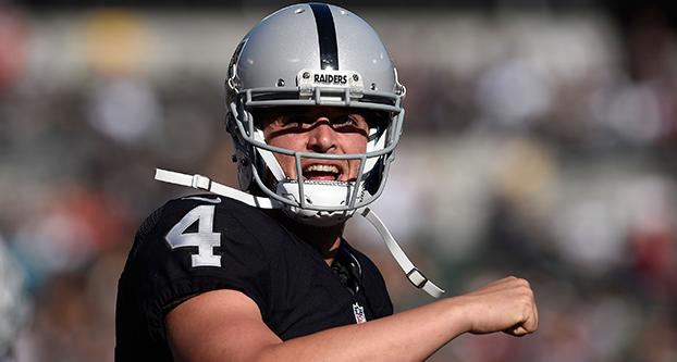 Oakland Raiders quarterback Derek Carr (4) reacts after throwing a six-yard touchdown pass to Oakland Raiders DeAndre Washington (33) in the first quarter of their preseason game at the Coliseum on Saturday, Aug. 27, 2016 in Oakland, Calif. (Jose Carlos Fajardo/Bay Area News Group/TNS)