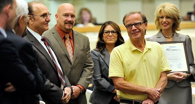 Retiring Fresno Bee reporter George Hostetter listens to tributes from members of the Fresno City Council, as they presented to him a surprise resolution naming Oct. 22, 2015 as George Hostetter Day for his service for the community. (John Walker/The Fresno Bee)