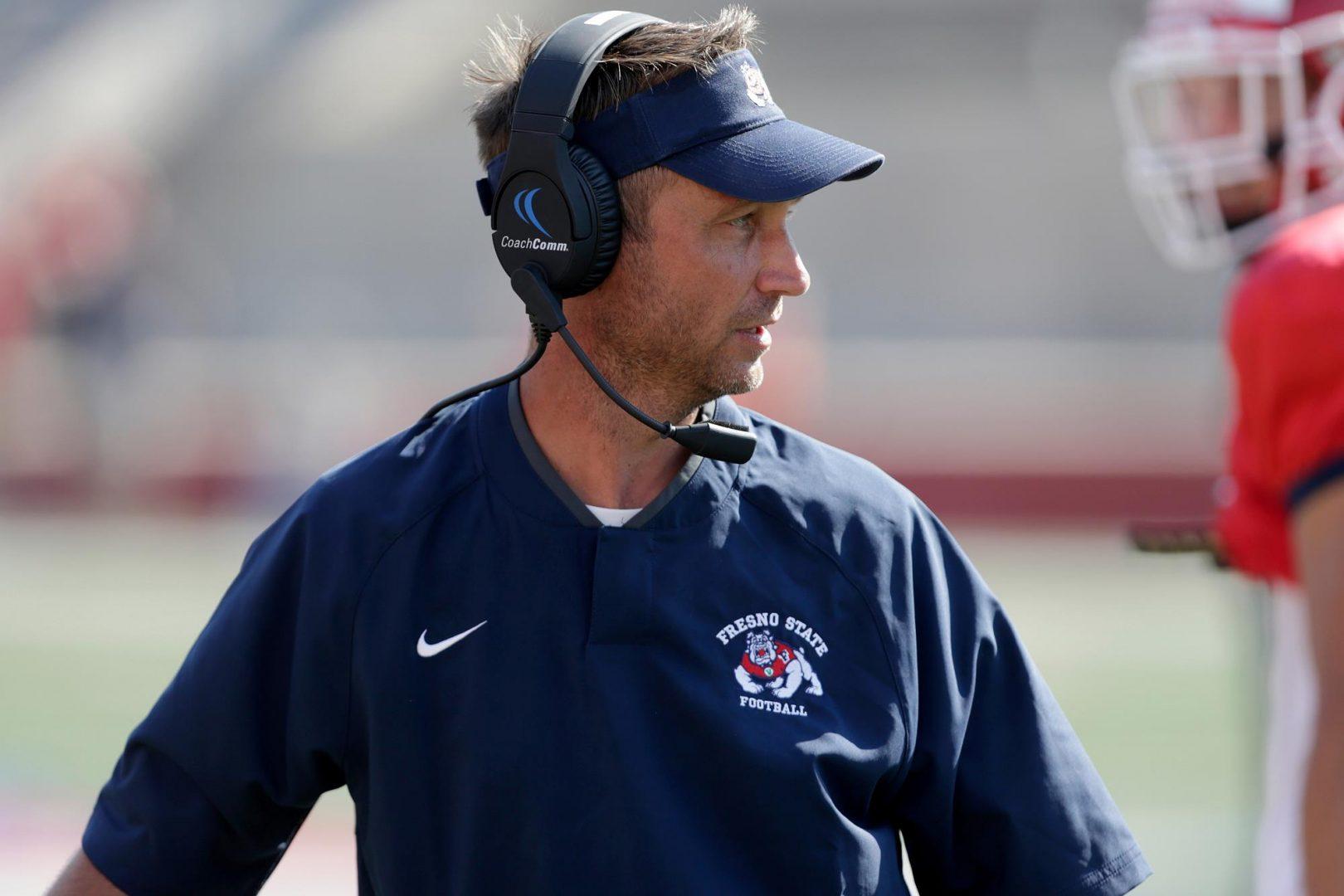 During a recent practice, assistant head coach and offensive coordinator Eric Kiesau acclimates himself with using a headset. (Fresno State Athletics)