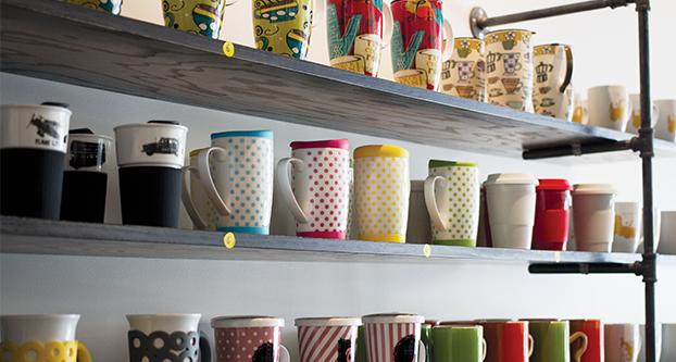 A vibrant shelf of mugs are displayed at Campus Pointe’s Collect Coffee Bar on Monday, Aug.30, 2016.  (Yezmene Fullilove/The Collegian)