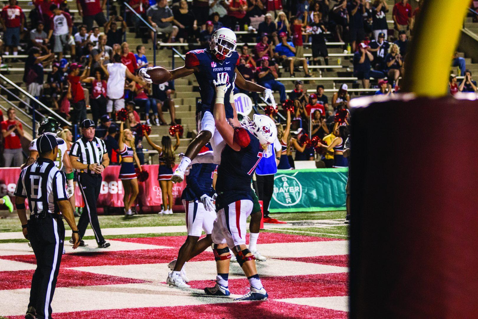 Wide receiver KeeSean Johnson (#3) celebrates in the endzone with teammates after scoring a touchdown on Saturday. (Khone Saysamongdy/The Collegian)