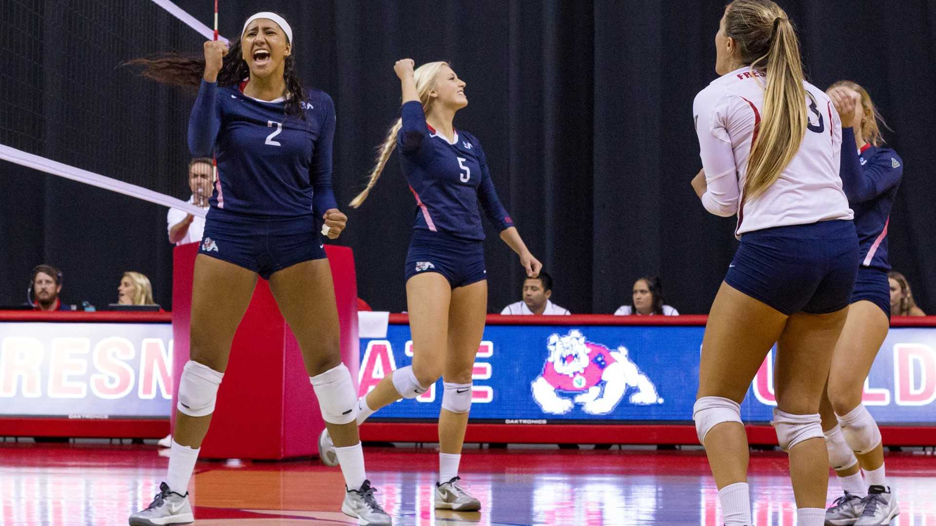 Lauren Torres (#2) and Madelyn Halteman (#5) celebrate with teammates after securing a win in their final nonconference  game. (Courtesy of Fresno State Athletics)