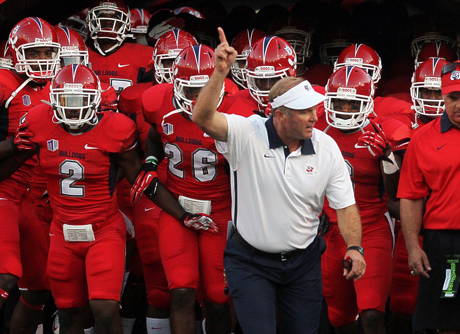 Fresno State head football coach Tim DeRuyter leads the team out of the tunnel before the start of his first game with the program, the season-opener against Weber State, at Bulldog Stadium in Fresno, California. (Craig Kohlruss/Fresno Bee/MCT)