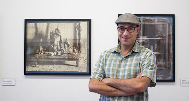 Neil Chowdhury stands with his displayed images at M Street Graduate Art Studios on Thursday, Sep.1, 2016. (Yezmene Fullilove/The Collegian).