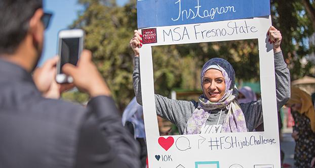 Kortney Seiler takes a picture with a hijab on during the “Hijab Challenge” event at the Free Speech Area on Oct. 6, 2016. (Khone Saysamongdy/The Collegian)