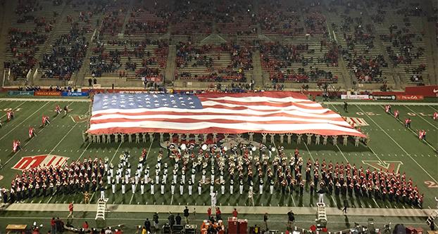 A 90-by-135-foot American flag was showcased and held by 200 people including military personnel and members of Mountain View Church of Fresno during Friday’s football game against Air Force Academy (Jenna Wilson/The Collegian). 
