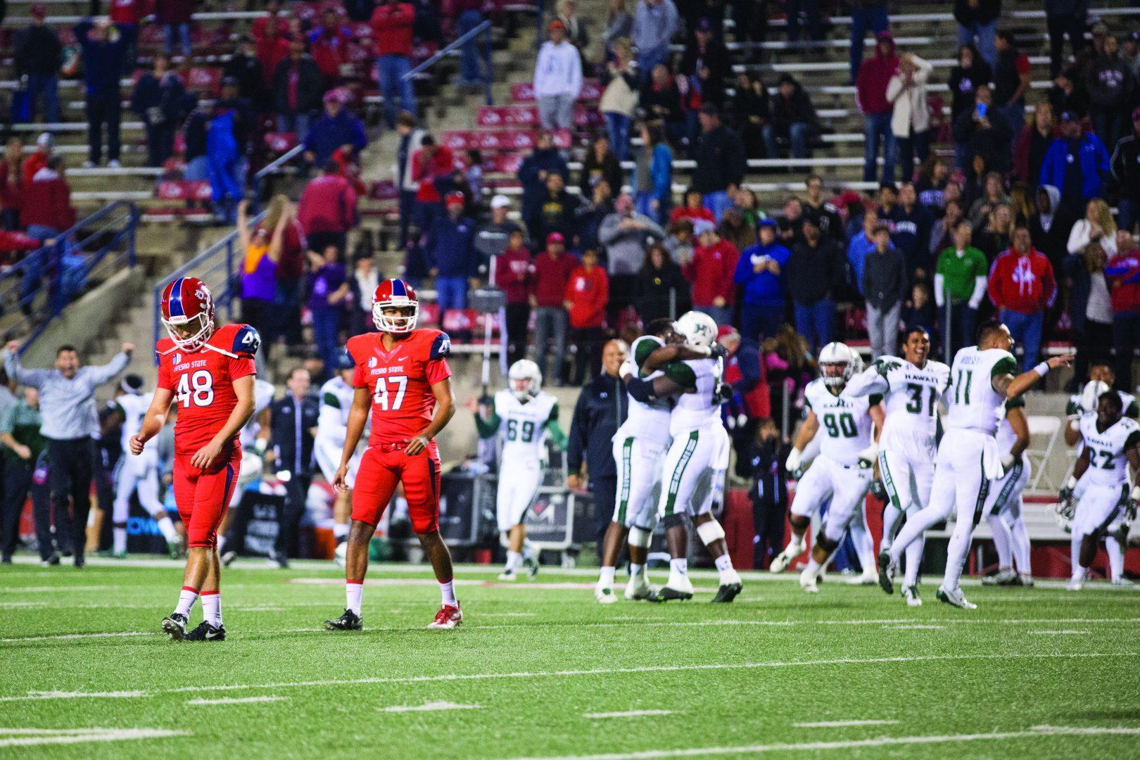 Hawai’i celebrates after Fresno State kicker Kody Kroening (#48) has his potential game-winning field goal blocked resulting in a 14-13 loss for the Bulldogs on Saturday night at Bulldog Stadium. (Christian Ortuno/The Collegian)