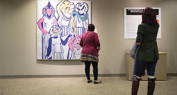 Fresno State Professor Kamy Martinez (left) and Fresno State Alumni Lorena Moreno (right)
view art at the “Mary Maughelli: Abstract Expressionism and Feminist Artwork” exhibit at the
Henry Madden Library on Friday, Nov. 4, 2016.  (Yezmene Fullilove / The Collegian)

