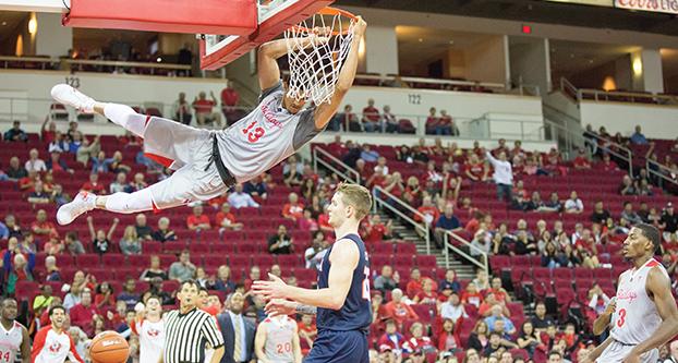 Senior forward Cullen Russo (#13) hangs on the rim after finishing a breakaway dunk in a game against the University of Texas at San Antonio (UTSA) on Friday, Nov. 11, 2016 at the Save Mart Center.” (Christian Ortuno/The Collegian)