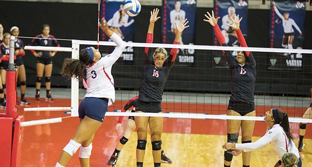 Senior outside hitter Aleisha Coates (#3) goes for a kill against San Diego State on Saturday afternoon at the Save Mart Center. (Christian Ortuno/The Collegian)