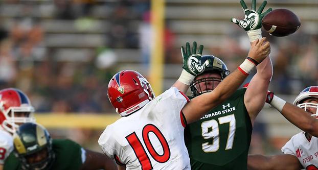 Senior quarterback Zach Kline (#10) attempts to throw past Colorado State’s defensive lineman Toby McBride (#97) in Saturday afternoon’s 37-0 shutout at Hughes Stadium in Fort Collins, Colorado. (Courtesy of Fresno State Athletics)