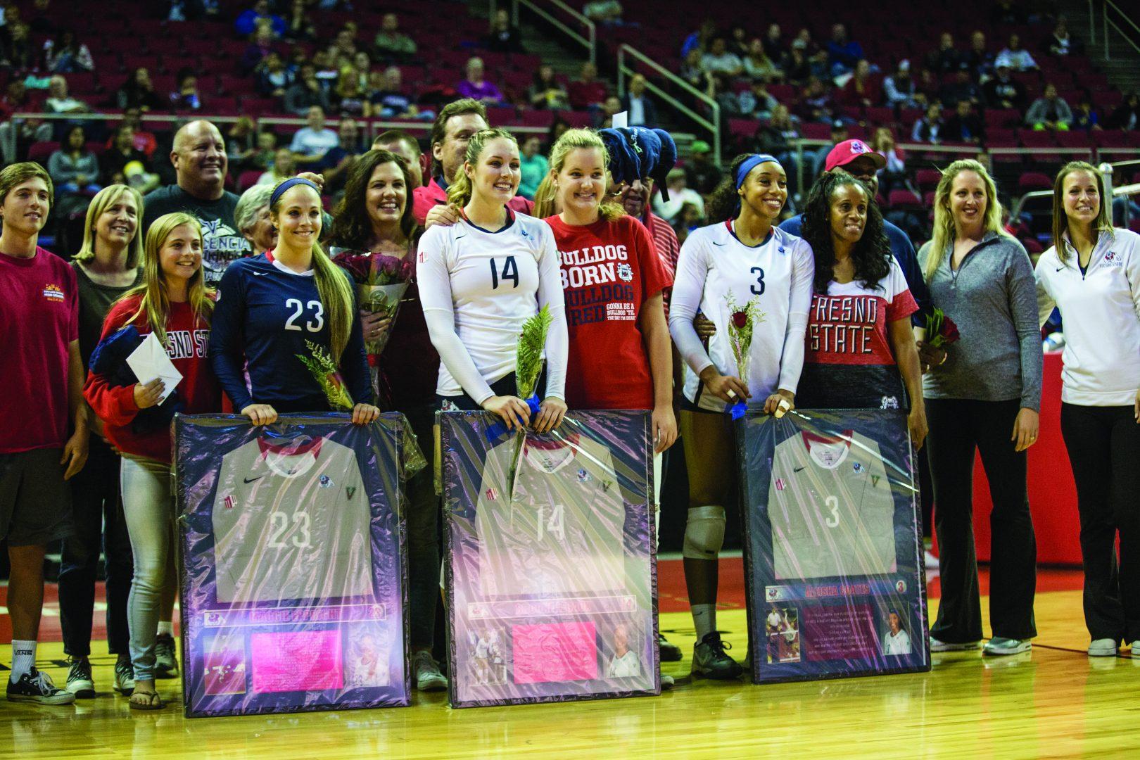 From left: Seniors Maggie Eppright (#23), Brooke Legeaux (#14) and Aleisha Coates (#3) are recognized at the Save Mart Center for Senior Salute Night before Wednesday’s game against the Utah State Aggies. (Khone Saysamongdy/The Collegian)