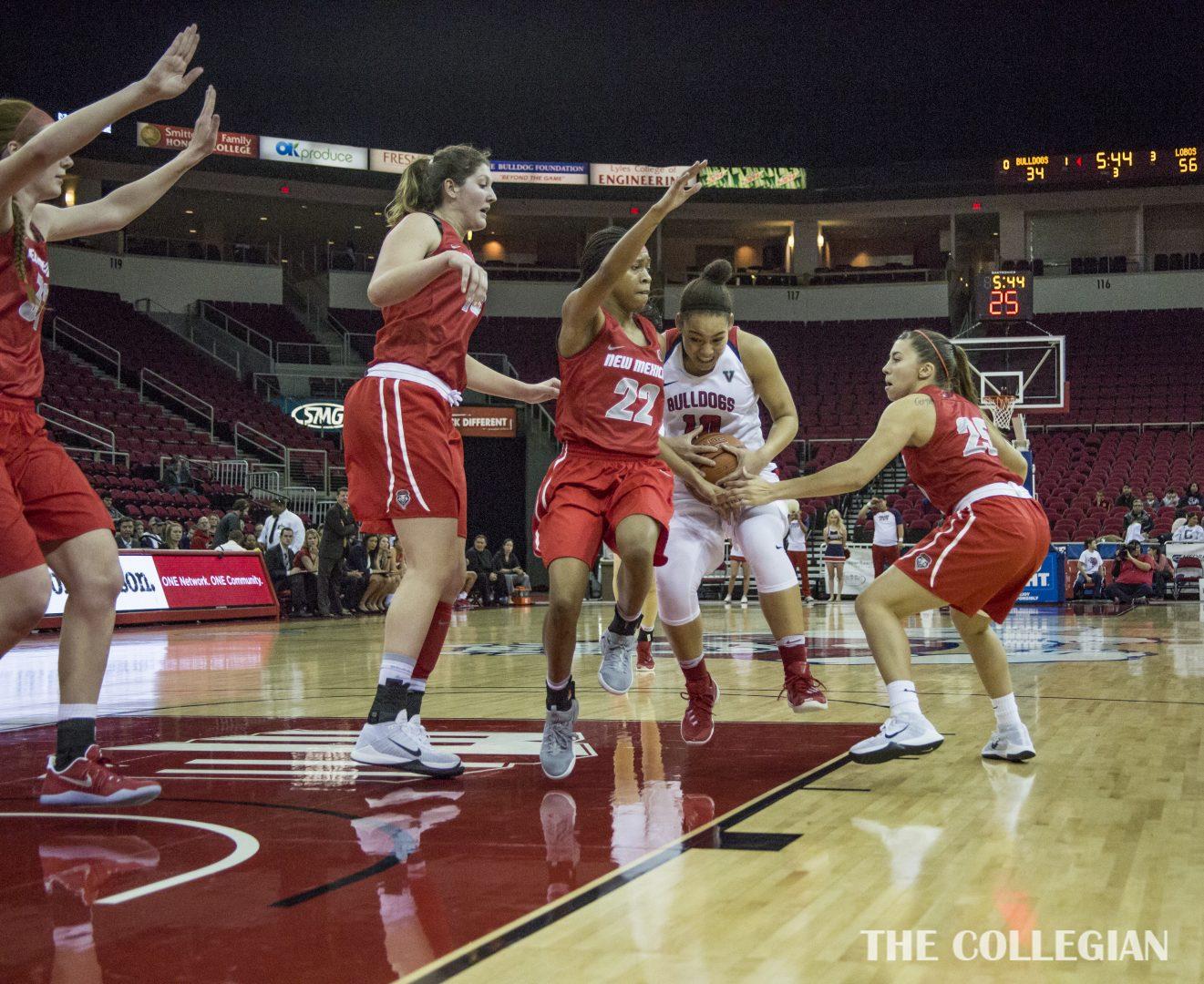 Fresno State sophomore guard Candice White (#10) is smothered by New Mexico defenders on Thursday, Dec. 29, 2016, at the Save Mart Center. (Khone Saysamongdy/The Collegian)