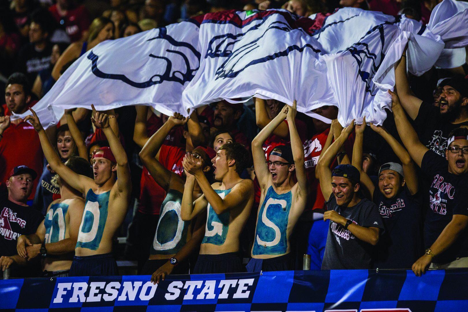 The Dog Pound cheering on the Fresno State football team at Bulldog Stadium. (Khone Saysamongdy/ The Collegian)