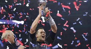 Tom Brady hoists the Lombardi Trophy, winning his fifth Super Bowl title, as the New England Patriots beat the Atlanta Falcons 34-28 in Super Bowl LI on Sunday, Feb. 5, 2017 at NRG Stadium in Houston, Texas. (Curtis Compton/Atlanta Journal-Constitution/TNS)