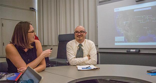 Jessica Daniel (left), Environmental Protection Specialist, with Jose L. Zambrana (right), Senior Science Advisor at the EPA’s Immediate Office of the Assistant Administrator, introduces the EviroAtlas tool in the Grosse Industrial Tech building on Feb. 14, 2017. (Khone Saysamongdy/The Collegian)