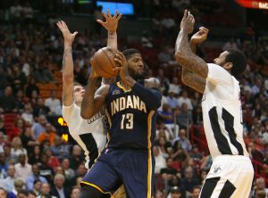 The Indiana Pacers Paul George (#13) looks to pass against the Miami Heats Tyler Johnson, left, and James Johnson during the fourth quarter at AmericanAirlines Arena in Miami on Wednesday, Dec. 14, 2016. The Heat won, 95-89. (David Santiago/El Nuevo Herald/TNS)