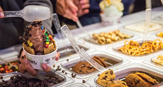 Customers pack their bowls with frozen yogurt and other food items at Yogurtland in Campus Pointe on Feb. 6, 2017. (Khone Saysamongdy/The Collegian)