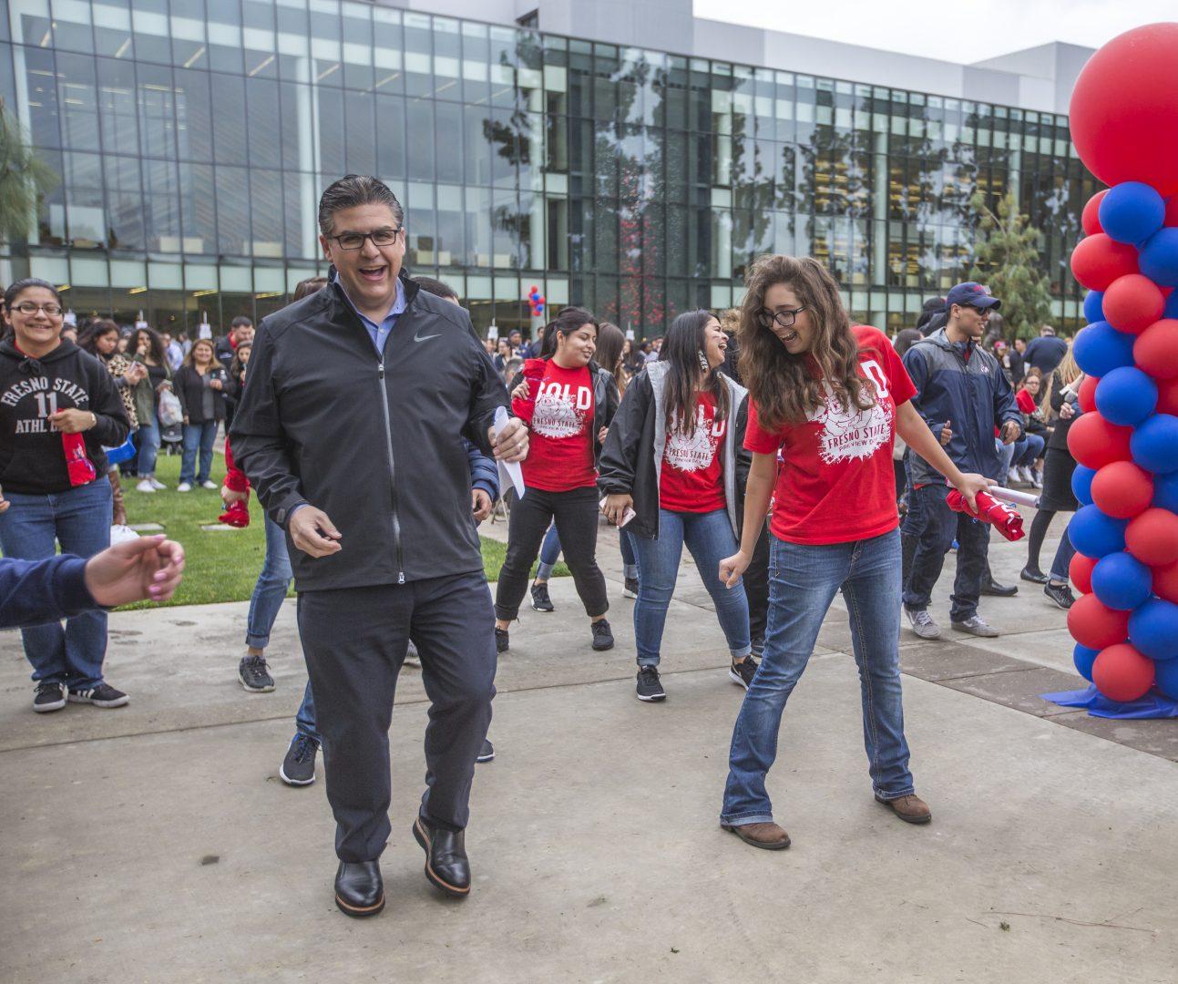 Fresno State President Joseph I. Castro (left) performs the “cupid shuffle” with the campus community on Preview Day, March 25, 2017. 