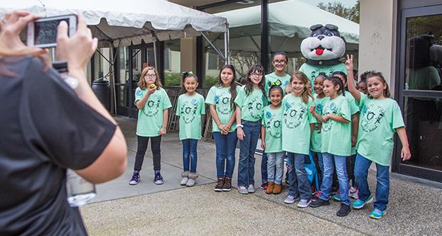 Cinnamon elementary takes a picture with Timeout during the Peach Blossom Festival event on March 10, 2017 (Khone Saysamongdy/The Collegian). 