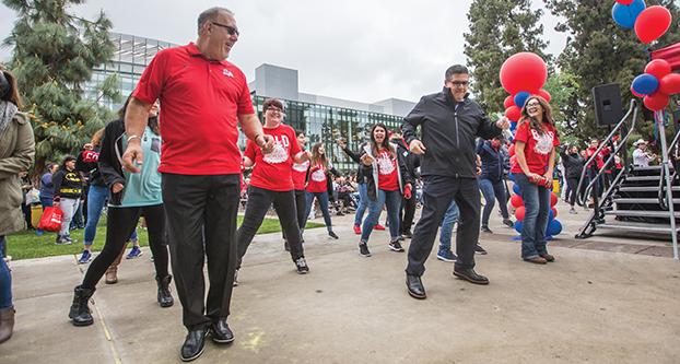 Vice President for Student Affairs Dr. Frank Lamas (left) and Fresno State President Joseph I. Castro (right) dances and performs the “cupid shuffle” at the Fresno State campus on Preview Day, March 25, 2017 (Khone Saysamongdy/ The Collegian). 