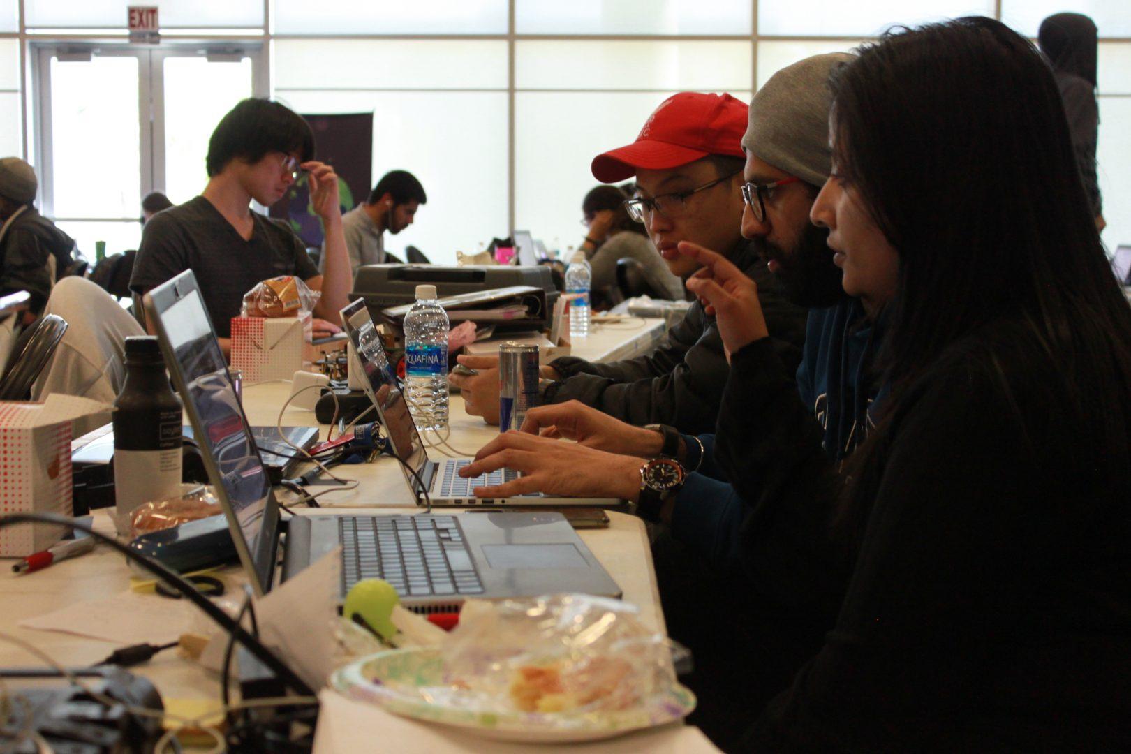 Students working together to finish their projects in the final hours of the 24-hour HackFresno hackathon i the North Gym on April 15, 2017. (Jessica Johnsen/The Collegian)