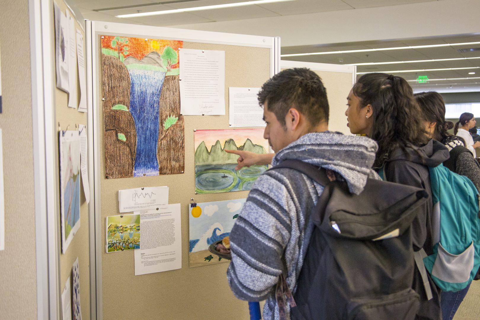 Fresno State students examine projects during the 4th annual interdisciplinary research open house in the Henry Madden Library on April 17, 2017.  (Khone Saysamongdy/ The Collegian)