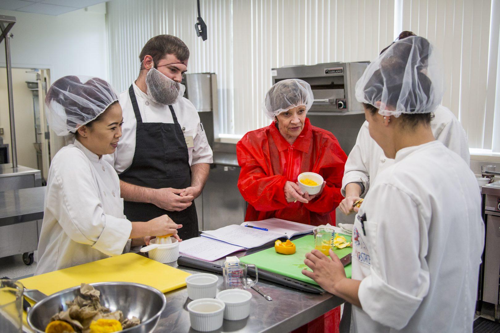 Secretary of the California Department of Food and Agriculture, Karen Ross, observes Fresno State students in the advance culinary art course in the Family and Food Science building room 108 on April 24, 2017. (Razmik Canas/ The Collegian)