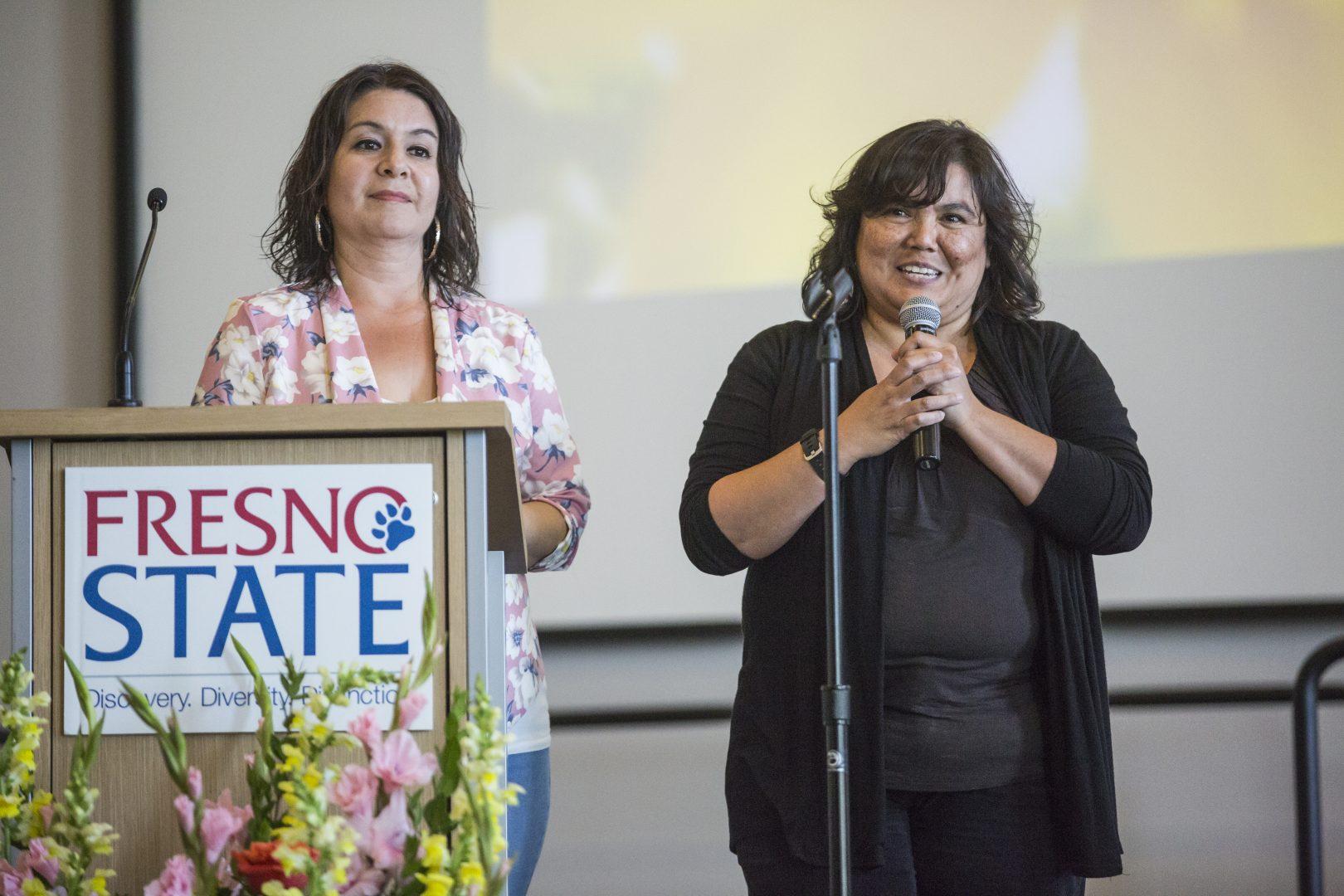 Irma Sanchez (left), founder of Deaf Latinos y Familias and Laura Lee Hasso, a deaf and hard of hearing teacher (right), gives a speech at the Silent Garden event in North Gym 118 on April 28, 2017.  (Khone Saysamongdy/ The Collegian)