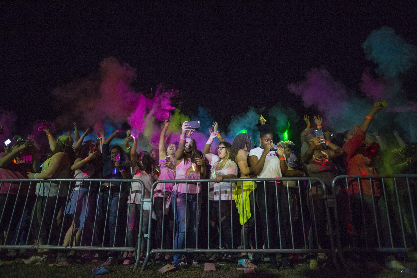 : Participants throw paint into the air during the Vintage Days Paint Party on campus Friday night, April 21, 2017. (Khone Saysamongdy/ The Collegian)