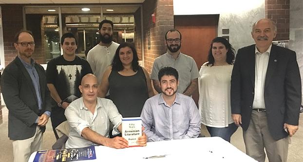 Christopher Atamian (seated left) and Barlow Der Mugrdechian (standing far right) with students from the Armenian Studies Program at Fresno State. (Christian Mattos/The Collegian)