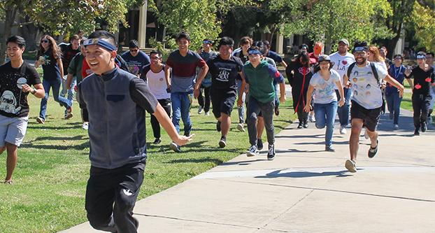 Students participating in the “Naruto Run” past the Speech Arts Building on Sept. 28, 2017 (Alvaro Lozano/The Collegian).
